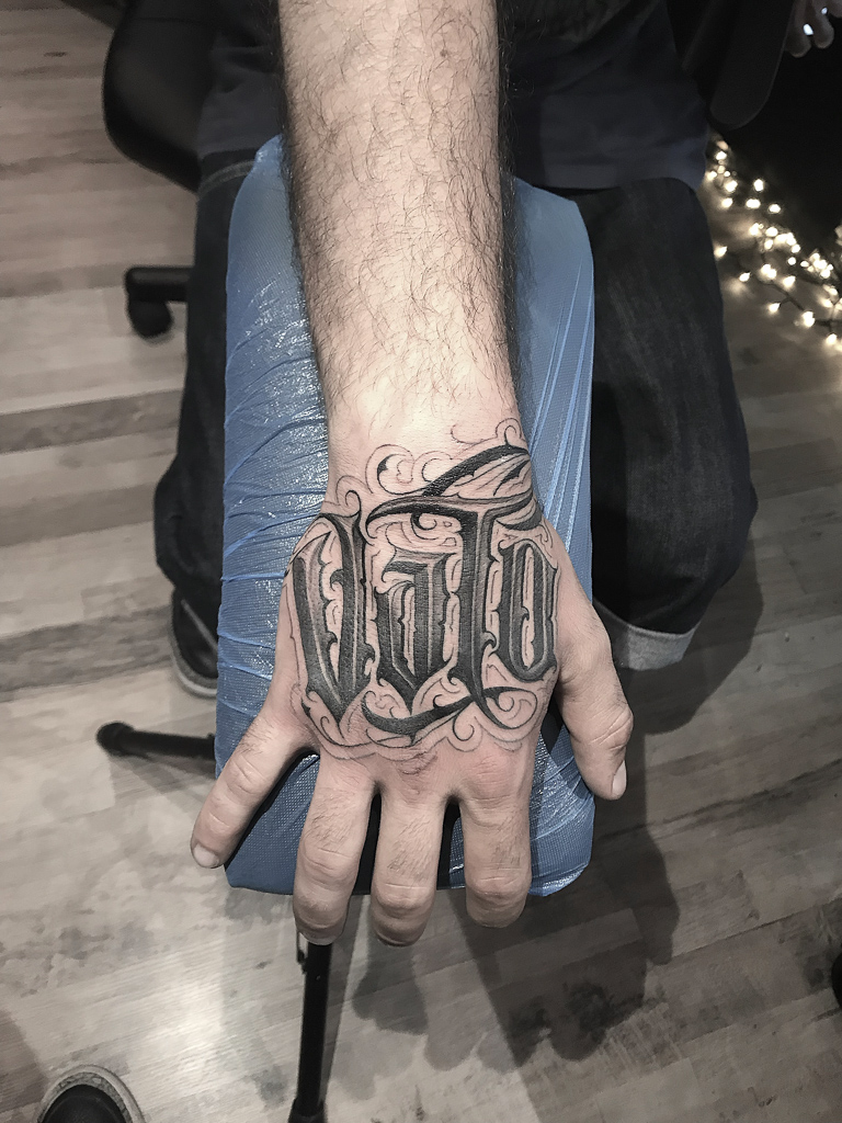 script hand tattoo